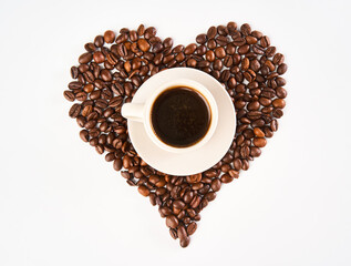 Cup of coffee isolated on white with a heart made of beans