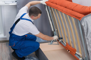 the master of sofa and bed maintenance repairs the mechanisms of the storage box