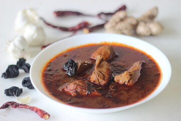 fish curry with red gravy prepared in traditional kerala style. Fish used is Bluefin trevally, locally known as vatta