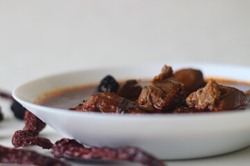 fish curry with red gravy prepared in traditional kerala style. Fish used is Bluefin trevally, locally known as vatta