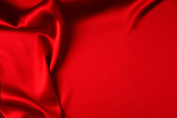 Red silk or satin luxury fabric texture can use as abstract background. Top view