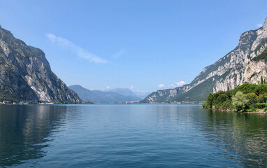 Obraz premium Beautiful landscape, panoramic view of mountain and lake Como in Lecco city, Italy, blue water and clear sky background