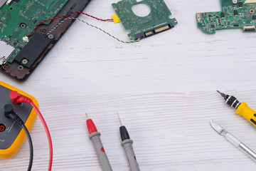 on a light background, a set of tools for repairing and replacing batteries and the smartphone...