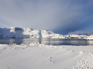 Snowy mountain and blue fjord lanscape in the arctic circle © Arcticphotoworks