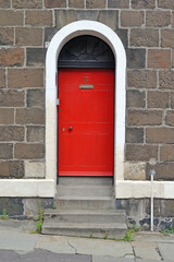 Stone Building with Stepped Entrance & Red Painted Door 