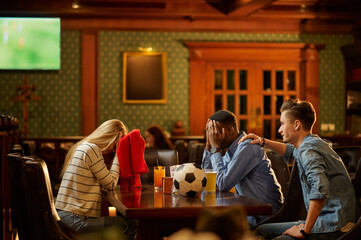 Football fans watching game translation in bar