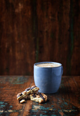 Cookie and Cappuccino on rustic wooden background. Close up. Copy space.