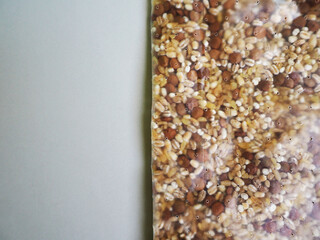 close in a bag with holes is a raw grain of barley lentils bulgur on a gray background top view . mix of cereals