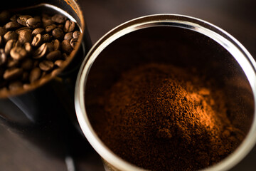 Ground coffee and coffee beans are in cans on the table. copy space. Banner for a caffeinated drink.