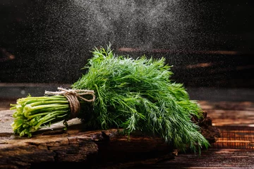 Foto op Aluminium A bunch of fresh raw green dill on wooden background with water drops © rostyslav84
