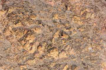 The cracked surface of a sheer cliff.