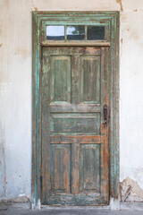 Vintage painted door in retro house. Textured door.
