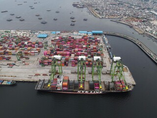 Aerial view of Container ship loading and unloading in deep sea port, import and export freight...