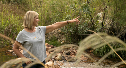 Woman in nature pointing