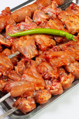 Raw marinated chicken on skewer 