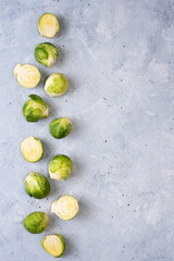 Row of fresh brussels sprouts on gray background.