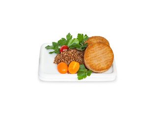 Two cutlets with buckwheat, greens and cherry tomatoes on white plate. White background, isolated, copy space.