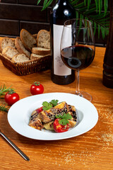 Eggplant and tomato salad with soy sauce and sesame seeds