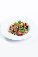 Eggplant and tomato salad with soy sauce and sesame seeds