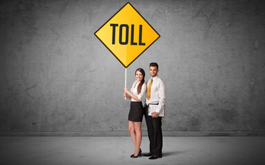 Young business person holding road sign