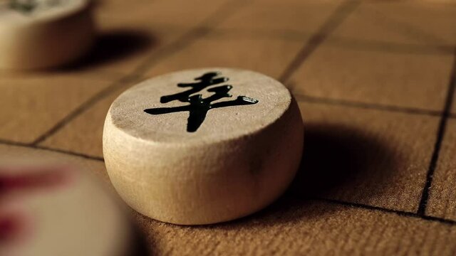 Close-up of moving a pawn on chessboard by hand, Chinese chess, picture text "pawn"