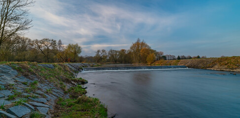 Malse river with big weir before sunrise in Budweis city