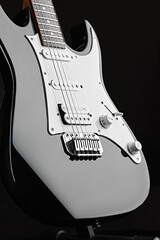 Obraz premium Modern electric guitar, black background, nobody