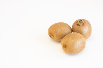 Whole fresh kiwi fruits isolated on white background with copy space for text