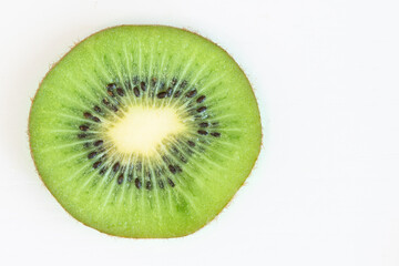 Close up fresh kiwi slice isolated on white background with copy space for text on right
