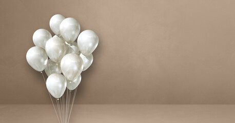 White balloons bunch on a beige wall background. Horizontal banner.