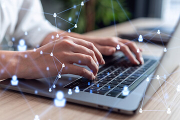 HR woman specialist is typing the keyboard in the internet to find the best candidates to create international network in recruitment process. Formal wear. Social media hologram icons.