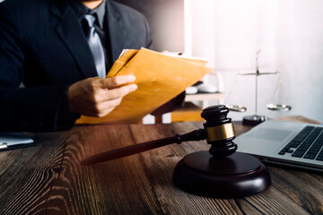 Business and lawyers discussing contract papers with brass scale on desk in office. Law, legal services, advice, justice and law concept picture with film grain effect
