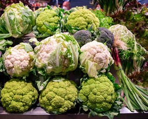 Set of fresh heads white and roman cauliflowers on the market. Healthy vegetarian food. Vegan concept.