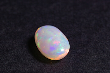 Colorful opal gem on black background