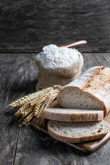 Fresh homemade bread and flour in small burlap bag