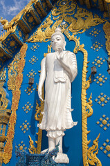 Big Buddha statue in Thai Lanna style - exterior detail of Famous Wat Rong Suea Ten, or Blue Temple in Chiangrai, Chiang Rai Province, Northern Thailand.