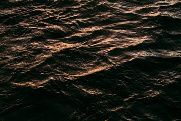 water waves illuminated by the sunset