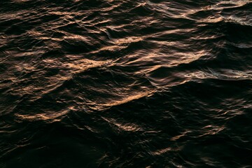 water waves illuminated by the sunset