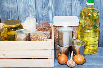 canned food and vegetable oil on a wooden shelf, food crisis