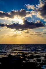 on the shore against the backdrop of the sunset at sea