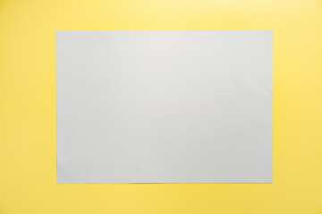 Gray frame on yellow background. Creative Flat lay Top view Mockup Copy space for text. Trendy colors 2021.