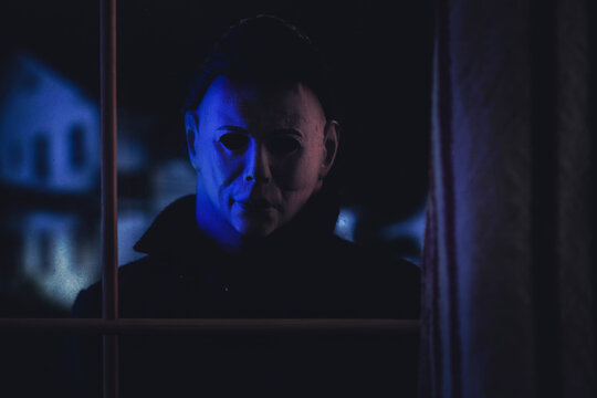NEW YORK USA: APRIL 14 2021: Halloween horror movie slasher Michael Myers staring through a window at the Doyle house - Trick or Treat Studios action figure