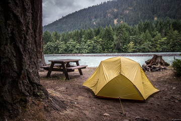 Camping tent in the forest mountains near the river
