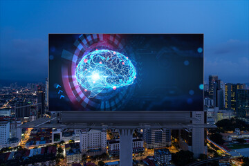 Brain hologram on billboard with Kuala Lumpur cityscape background at night time. Street...