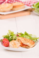 Puff pastry filled with tomato and mozzarella cheese.