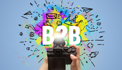Close-up of a hand holding digital camera with abstract drawing