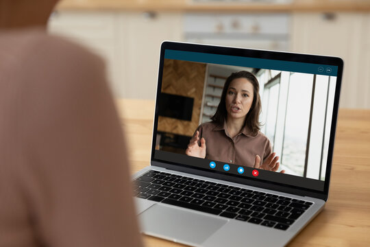 Webcam portrait of young female applicant talk answer employer question on distant job interview. Over shoulder view of client watch webinar training on laptop online listen to woman coach explanation - Powered by Adobe