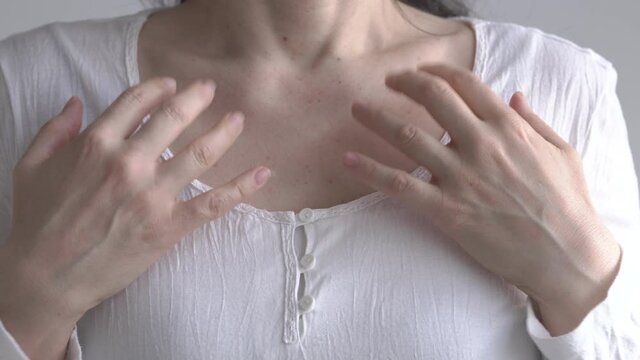 Woman practicing EFT - tapping on the collarbone point