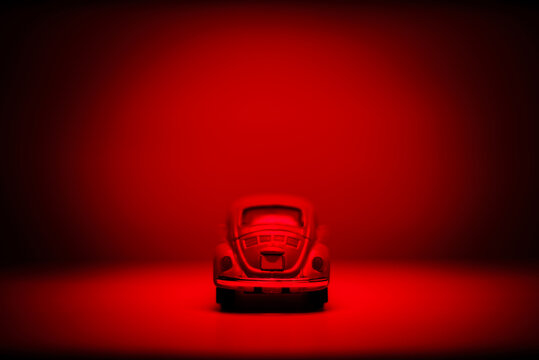 Rear View Of A Toy Model Car Under Red Light.