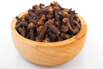 Clove, clove seed. Macro shot, Clove seed in wooden bowl,  on white background